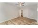 A neutral bedroom features light hardwood floors, a ceiling fan, and a closet for ample storage at 305 Pawley Dr, Charlotte, NC 28214