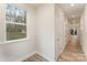 Bright hallway with doors, wood floors, and natural light from a window with a view at 305 Pawley Dr, Charlotte, NC 28214