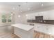 A kitchen with a center island, stainless steel appliances and dark backsplash against white cabinets at 305 Pawley Dr, Charlotte, NC 28214