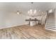 Open concept living space with kitchen, stairs, and hardwood flooring at 305 Pawley Dr, Charlotte, NC 28214