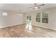 Bright living room featuring hardwood floors, a ceiling fan, large windows and a sliding glass door at 305 Pawley Dr, Charlotte, NC 28214