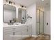 Modern bathroom with double vanity sinks, a glass shower, and sleek black fixtures at 309 Pawley Dr, Charlotte, NC 28214