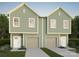 Charming townhome featuring a two-car garage, modern windows, and light green siding at 309 Pawley Dr, Charlotte, NC 28214