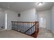 Upstairs hallway with wooden railing and carpet at 4126 Kellybrook Dr, Concord, NC 28025