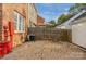 Backyard featuring brick-paved patio, bordered by a wooden fence, offering a private outdoor space at 8336 Indigo Row, Charlotte, NC 28277