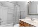 A bathroom featuring a shower with tub, white shower curtain and wood vanity at 8336 Indigo Row, Charlotte, NC 28277