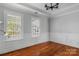 Bright, airy bedroom with hardwood floors, wainscoting, and large windows at 8336 Indigo Row, Charlotte, NC 28277