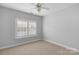 This bedroom features a neutral carpet and a window providing natural light at 8336 Indigo Row, Charlotte, NC 28277