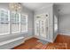 Bright breakfast nook with a built-in bench seat, chandelier, and French doors at 8336 Indigo Row, Charlotte, NC 28277