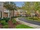 A row of well-maintained brick townhouses with lush landscaping and a curved street at 8336 Indigo Row, Charlotte, NC 28277