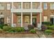 Inviting townhouse exterior showcasing a columned porch and well-maintained landscaping at 8336 Indigo Row, Charlotte, NC 28277