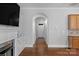 Hallway view featuring hardwood floors and an arched doorway at 8336 Indigo Row, Charlotte, NC 28277