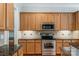 Close up of a Kitchen showcasing the stainless steel appliances and granite countertops at 8336 Indigo Row, Charlotte, NC 28277