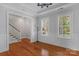 Bright living room with hardwood floors, wainscoting, and an open layout to the staircase at 8336 Indigo Row, Charlotte, NC 28277