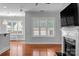 Bright living room showcasing a fireplace, large windows, and hardwood flooring at 8336 Indigo Row, Charlotte, NC 28277