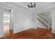 Elegant living room featuring hardwood floors, wainscoting, and staircase access at 8336 Indigo Row, Charlotte, NC 28277