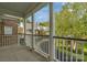 View from a column-lined porch overlooking neighborhood street and landscaping at 8336 Indigo Row, Charlotte, NC 28277