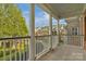 View from a column-lined porch of neighborhood street with tree-lined sidewalks at 8336 Indigo Row, Charlotte, NC 28277