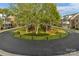 Aerial view of a circular street lined with trees and manicured lawns at 8336 Indigo Row, Charlotte, NC 28277