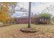 Landscaped backyard with trees and stone planter at 8724 Old Plank Rd, Charlotte, NC 28216