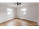 Well-lit bedroom featuring hardwood floors and neutral walls at 8724 Old Plank Rd, Charlotte, NC 28216