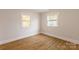 Bright bedroom with hardwood floors and two large windows at 8724 Old Plank Rd, Charlotte, NC 28216