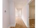 Hardwood floor hallway with doors leading to other rooms at 8724 Old Plank Rd, Charlotte, NC 28216