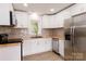 Renovated kitchen featuring new cabinets, countertops, and stainless steel appliances at 8724 Old Plank Rd, Charlotte, NC 28216