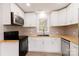 Modern kitchen with white cabinets, butcher block counters, and stainless steel appliances at 8724 Old Plank Rd, Charlotte, NC 28216