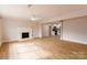 Open living room with hardwood floors and a fireplace at 8724 Old Plank Rd, Charlotte, NC 28216