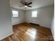 Hardwood floor bedroom with ceiling fan and two windows at 925 Rock Grove Church Rd, Salisbury, NC 28146