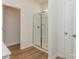 Bathroom features a glass enclosed shower, and wood-look flooring at 1150 Red River Dr, Salisbury, NC 28144