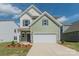 Charming two-story home with a two-car garage, green siding and landscaped yard at 1150 Red River Dr, Salisbury, NC 28144
