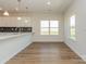 Open kitchen with white cabinets, modern countertops, a kitchen island, and wood flooring at 1150 Red River Dr, Salisbury, NC 28144