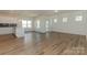 Open concept living room and kitchen area with hardwood floors and modern fixtures at 1150 Red River Dr, Salisbury, NC 28144