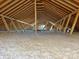 Unfinished attic space with exposed wooden beams and insulation at 13000 John Bostar Ln, Charlotte, NC 28215