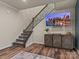 Basement stairwell with wood flooring and modern metal railing at 18014 Pear Hawthorne Dr, Huntersville, NC 28078