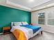 Bedroom with teal accent wall, double windows, and carpet at 18014 Pear Hawthorne Dr, Huntersville, NC 28078