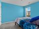 Light blue bedroom with a double bed and window at 18014 Pear Hawthorne Dr, Huntersville, NC 28078