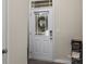 Front entry door with glass panel and wreath, hardwood floor at 18014 Pear Hawthorne Dr, Huntersville, NC 28078