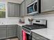Gray kitchen cabinets, white countertops, and stainless steel appliances at 18014 Pear Hawthorne Dr, Huntersville, NC 28078