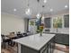 Modern kitchen with island, stainless steel appliances, and access to backyard at 18014 Pear Hawthorne Dr, Huntersville, NC 28078