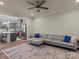 Living room with gray sectional and open kitchen in background at 18014 Pear Hawthorne Dr, Huntersville, NC 28078