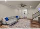 L-shaped gray sectional sofa in living room with hardwood floor at 18014 Pear Hawthorne Dr, Huntersville, NC 28078