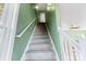 Interior staircase with gray carpeting and sage green walls at 18819 Cloverstone Cir, Cornelius, NC 28031