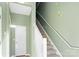 Interior staircase with white railing and sage green walls at 18819 Cloverstone Cir, Cornelius, NC 28031