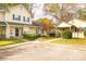Attractive townhome exterior featuring coordinated doors, sidewalks, and established trees at 2702 New Hamlin Way, Charlotte, NC 28210