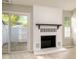 Bright living room featuring a white brick fireplace and access to outdoor patio at 2702 New Hamlin Way, Charlotte, NC 28210