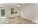 Bright bedroom featuring hardwood floors, a ceiling fan, a sliding door and a large window at 2817 New Pineola Rd # 6A, Charlotte, NC 28208