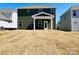 Backyard featuring a modern siding, covered porch, and lawn at 3031 Puddle Pond Rd, Indian Trail, NC 28079